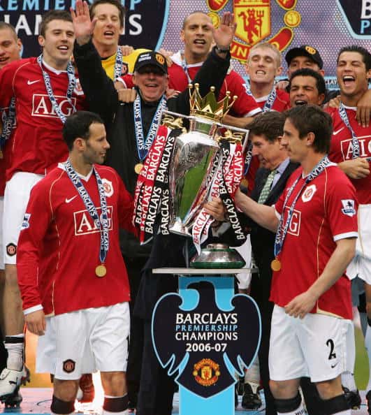 Manchester United Manager Sir Alex Ferguson celebrates as Ryan Giggs (L) and Gary Neville of Manchester United lift the Premiership trophy 2007