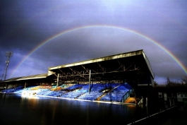 A rainbow forms over the stands at a flooded Gay Meadow, home of Shrewsbury Town
