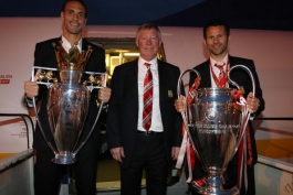 Sir Alex Ferguson, Ryan Giggs and Rio Ferdinand of Manchester United pose with the UEFA Champions League trophy and the FA Barclays Premier League trophy 2008