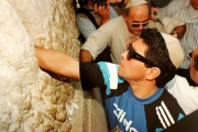 Diego Maradona puts a note with a secret wish in between the stones of the Wailing Wall in Jerusalem’s Old City 30 May