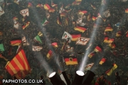 West German fans wave flags in front of spotlights at the World Cup Final in the Olympic Stadium, Rome